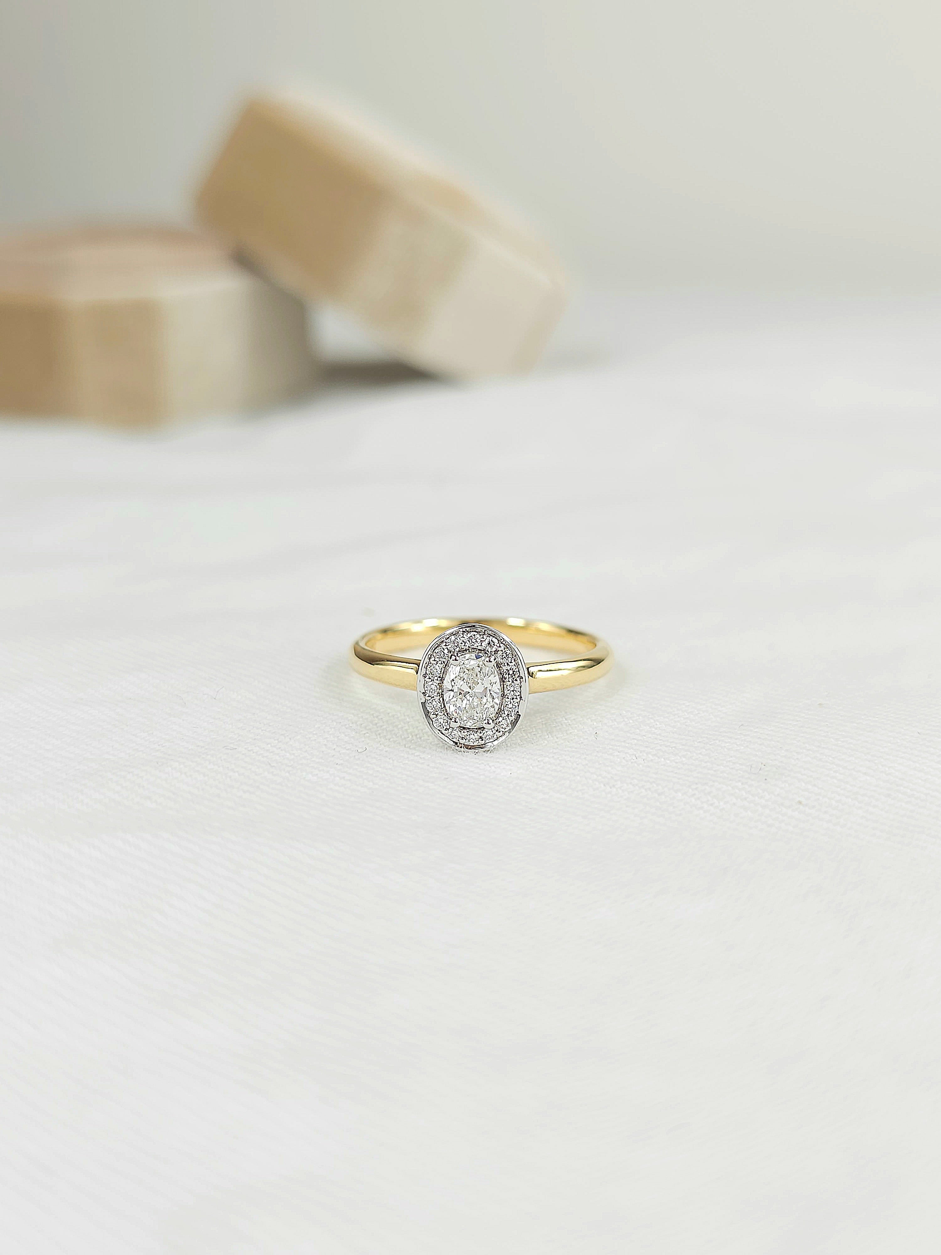 18ct Yellow and White Gold Oval Halo engagement ring, 0.30ct centre