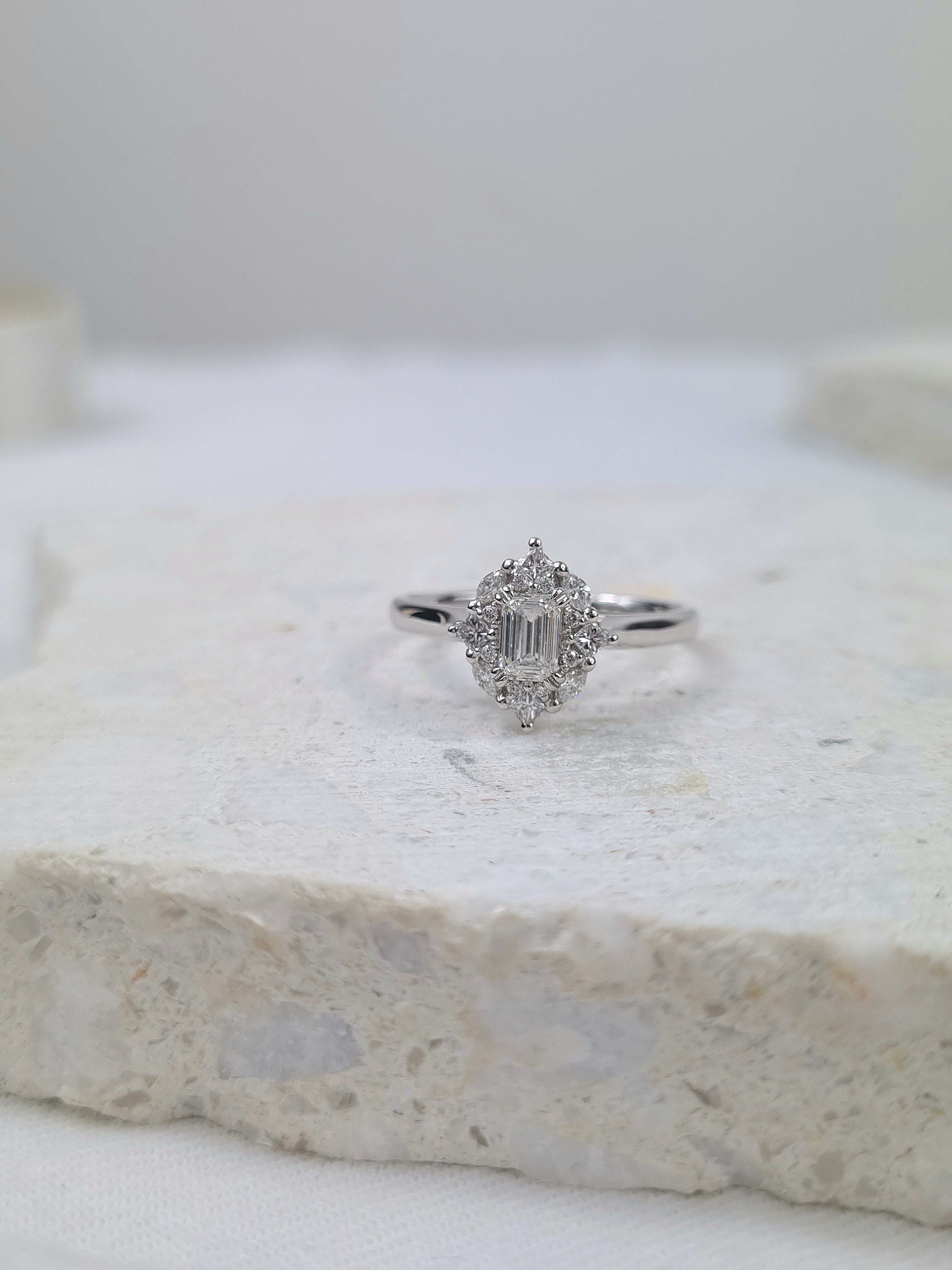 18ct Gold Emerald Cut Halo Diamond Ring, 0.61 carats.